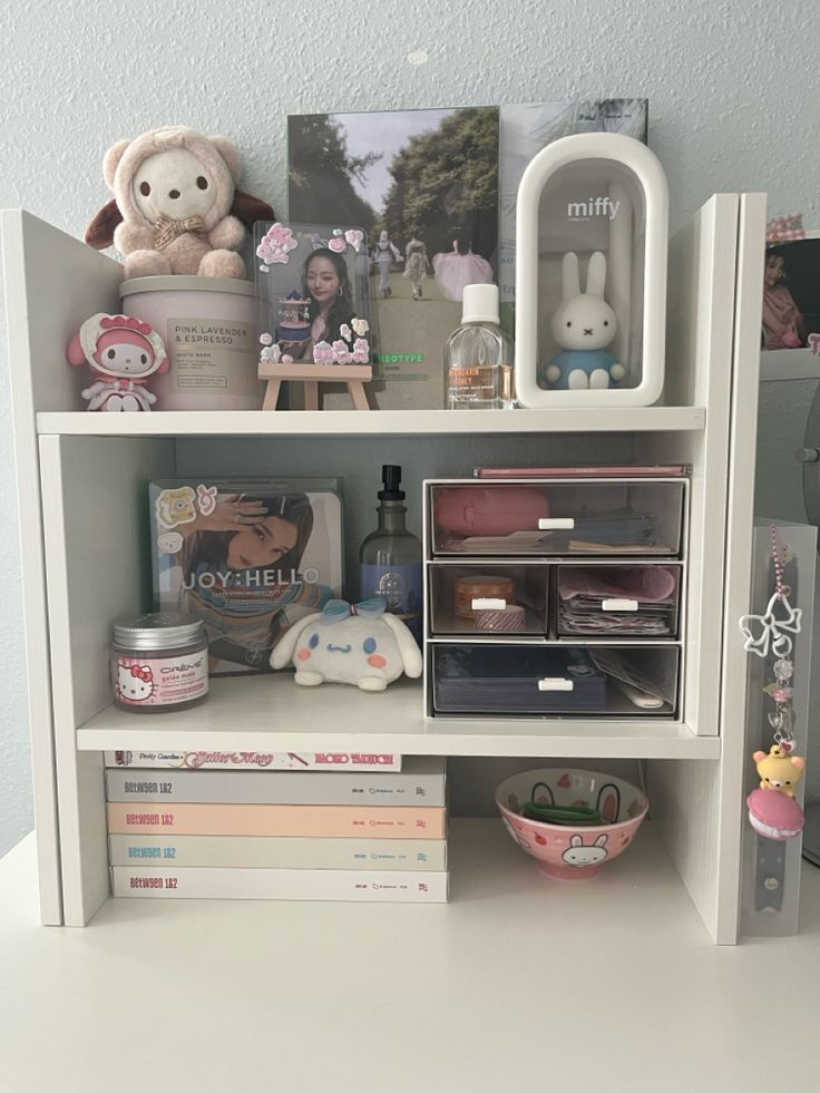 a book shelf filled with lots of books and stuffed animals on top of it's shelves