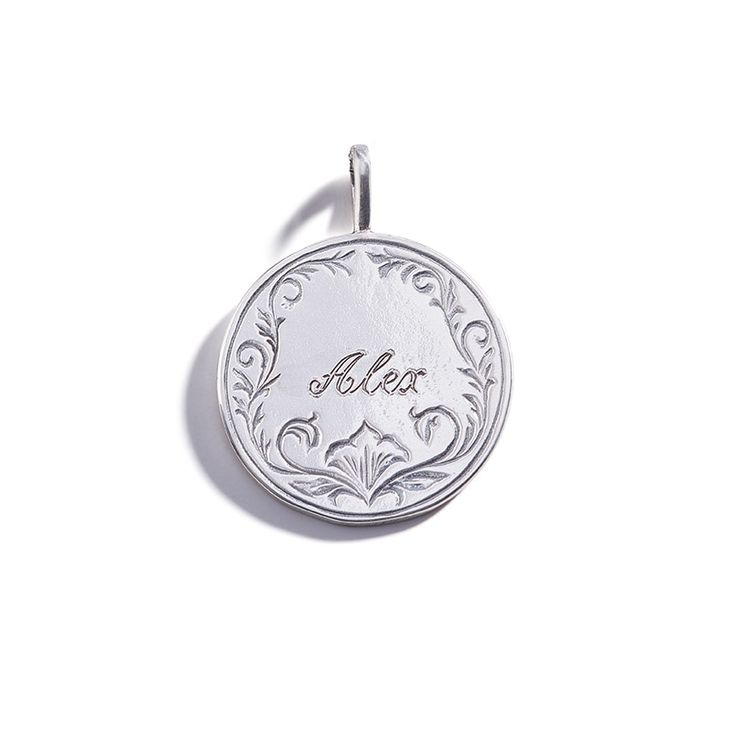 About This Personalized Piece Measurements & Materials Included: One Charm. Chain sold separately. Charm Measurements: 3/4" Charm Metal:  Sterling Silver Complementary Charms: To add additional charms to this design, please use the A La Carte Section. Charms noted below under “Other Pieces You Will Love” pair well with this design. MADE FROM RECYCLED GOLD & SILVER  -  HANDMADE IN CALIFORNIA Inspiration & Styling  Popular during the Victorian Era, "Love Tokens Elegant Engraved Jewelry For Memorial, White Gold Nameplate Jewelry With Engraving Option, Classic Silver Jewelry With Engraved Text, Heirloom Pendant Charms For Gifts, Etched Sterling Silver Coin Jewelry, Anniversary Jewelry With Engraving Option On Round Disc, Heirloom Pendant Charms For Gift, Personalized Medallion Charms For Gifts, Sterling Silver Etched Coin Jewelry