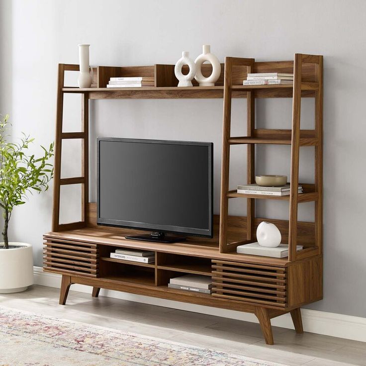 an entertainment center with shelves and a television