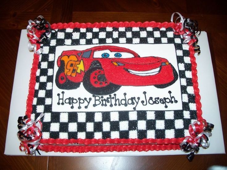 a birthday cake for a child's first birthday with cars and checkered border