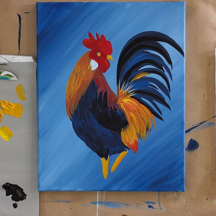 a painting of a rooster on a blue background next to paintbrushes and watercolors