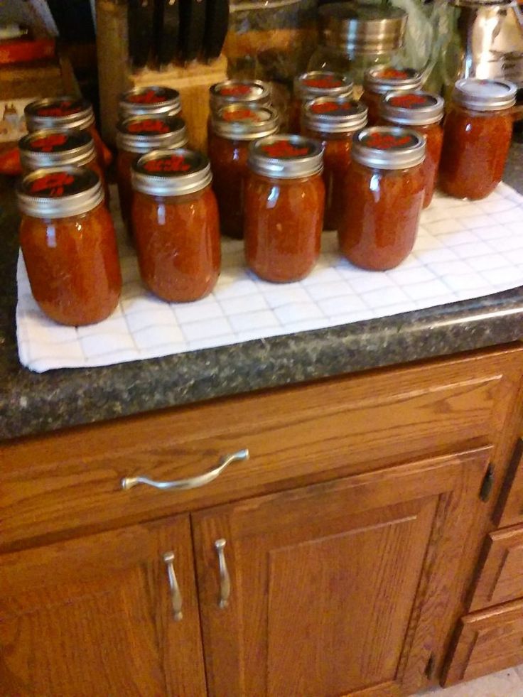 many jars are lined up on the counter