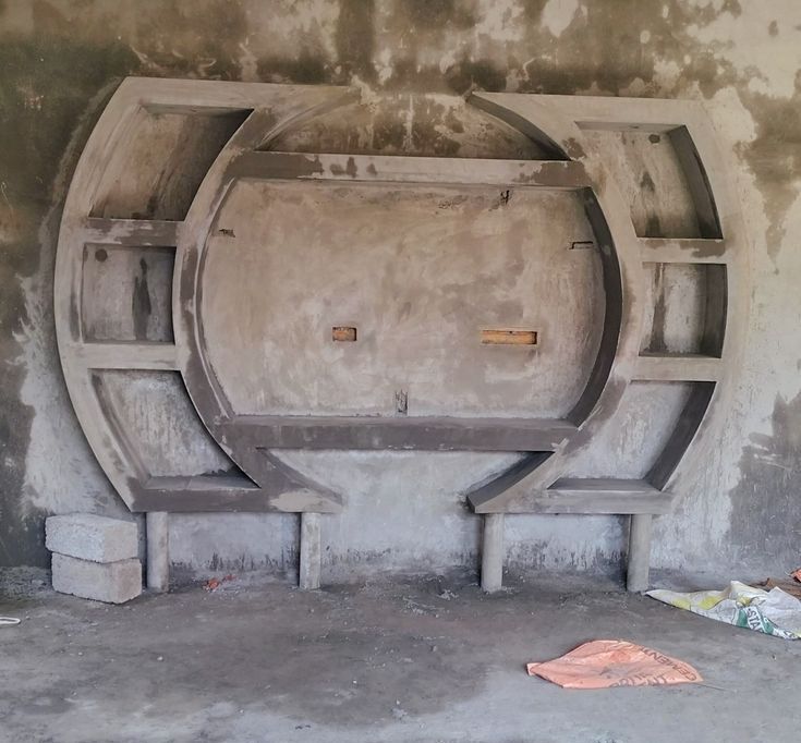 an empty room with cement walls and benches