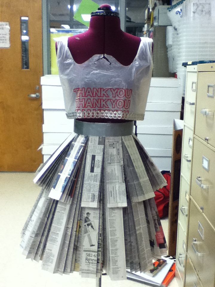 a dress made out of newspapers sitting on top of a table