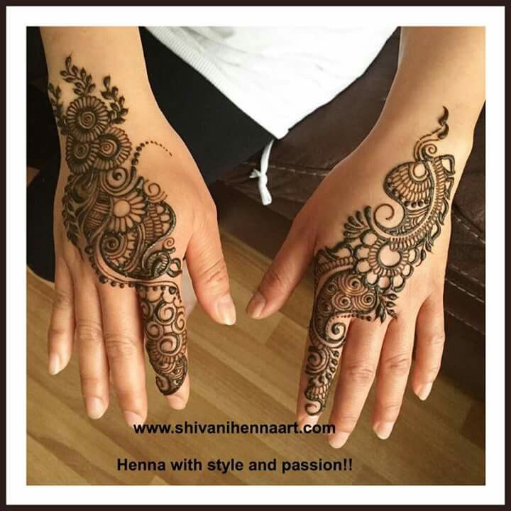 two hands with henna designs on them