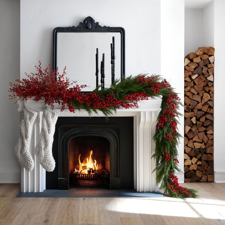 a fireplace decorated for christmas with stockings and holly wreaths on the mantel above it