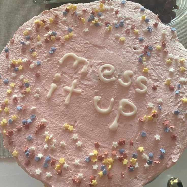 a pink frosted cake with stars on it