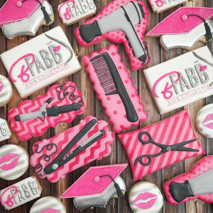 decorated cookies with pink icing and black hairdryers on them are arranged in the shape of women's accessories