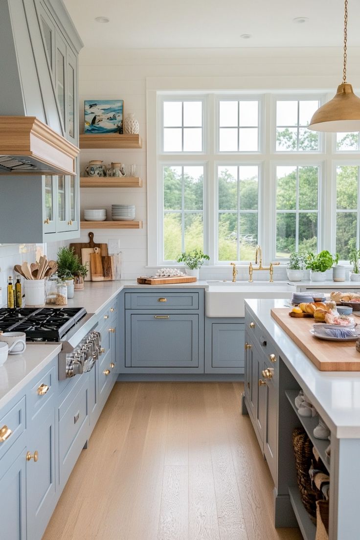 a kitchen filled with lots of counter top space and wooden flooring next to a window