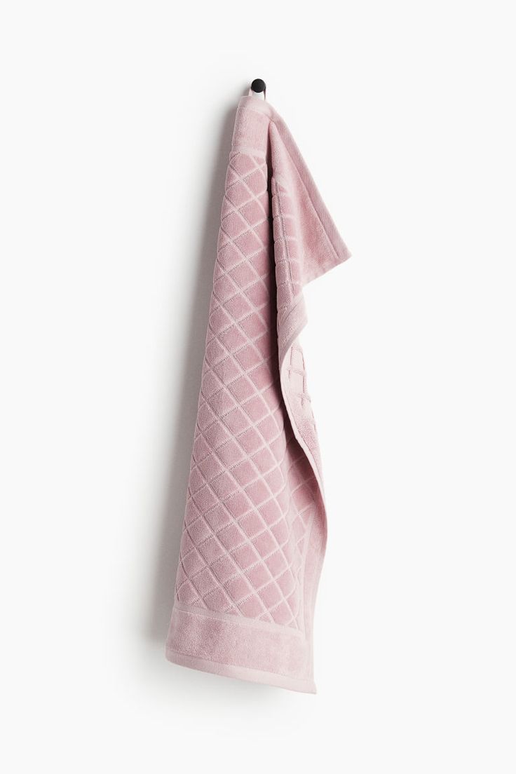 a pink towel hanging on the wall