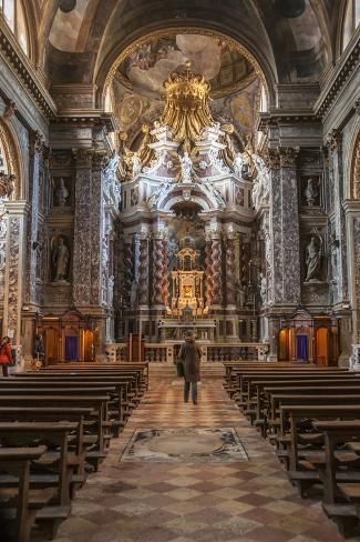 the interior of an old church with pews