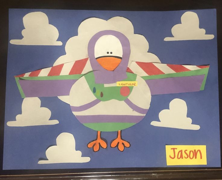 a paper cut out of a bird with clouds in the background and a name tag on it