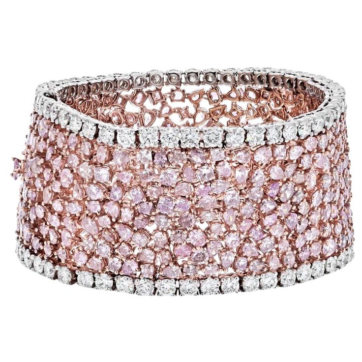 Indulge in the mesmerizing allure of this exquisite diamond bracelet, a testament to sophistication and artistry. Designed with a highly flexible band, it showcases a captivating array of radiant, oval, and pear-cut diamonds, each adorned with various Fancy Pink hues, totaling approximately 47 carats. The intricate arrangement of these pink diamonds is complemented by lines of round-cut near-colorless diamonds, totaling 8.16 carats, creating a harmonious blend of color and brilliance. The bracel Modern Bracelets, Platinum Rose Gold, Colorless Diamond, Expensive Jewelry, Rose Gold Bracelet, Rose Gold Metal, Pink Stone, Pink Diamond, Stone Bracelet