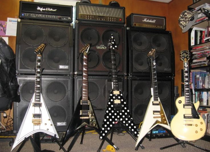 guitars and amps lined up in a room