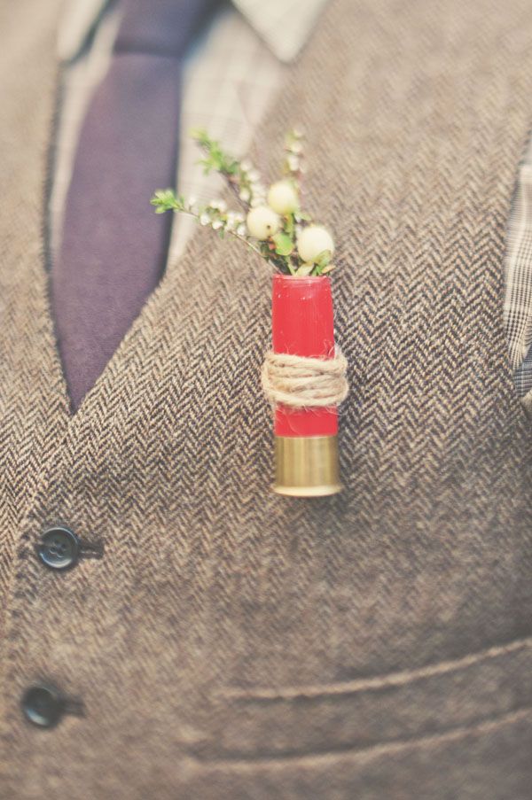 a man wearing a suit and tie with a boutonniere on his lapel