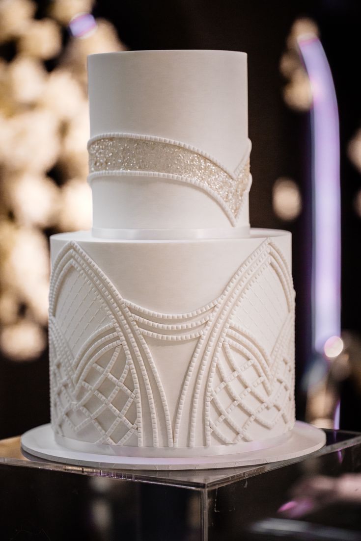 a white wedding cake sitting on top of a table