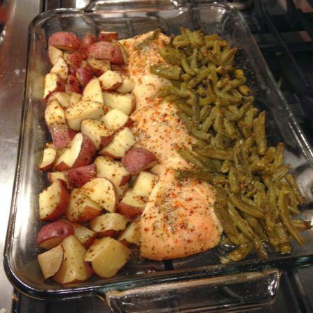 the meal is prepared and ready to be eaten in the oven, including chicken, potatoes, and green beans