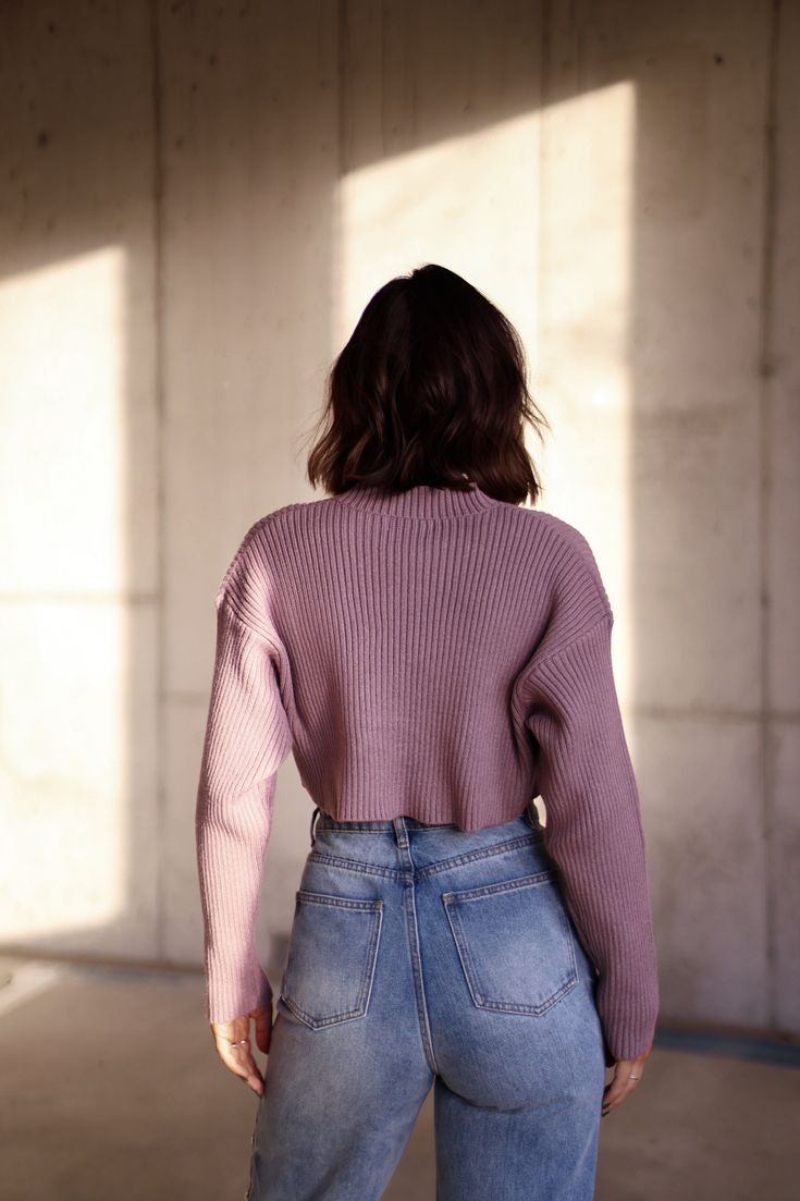 This Dusty Purple Cropped Sweater features long sleeves and a ribbed, mock neck design. Its cropped style adds a trendy touch to your wardrobe while keeping you comfortably warm. Perfect for pairing with high-waisted bottoms or layering over dresses for a stylish look. Fabric 50% viscose, 29% nylon, 21% polyester Chic Winter Cropped Sweater With Funnel Neck, Trendy Long Sleeve Turtleneck With Ribbed Cuffs, Trendy High Neck Turtleneck With Ribbed Cuffs, Chic Cropped Sweater With Ribbed Collar For Spring, Chic Fall Cropped Turtleneck Sweater, Chic Fall Turtleneck Cropped Sweater, Chic Turtleneck Cropped Sweater For Fall, Chic Turtleneck Cropped Sweater For Winter, Fall Mock Neck Top With Ribbed Collar