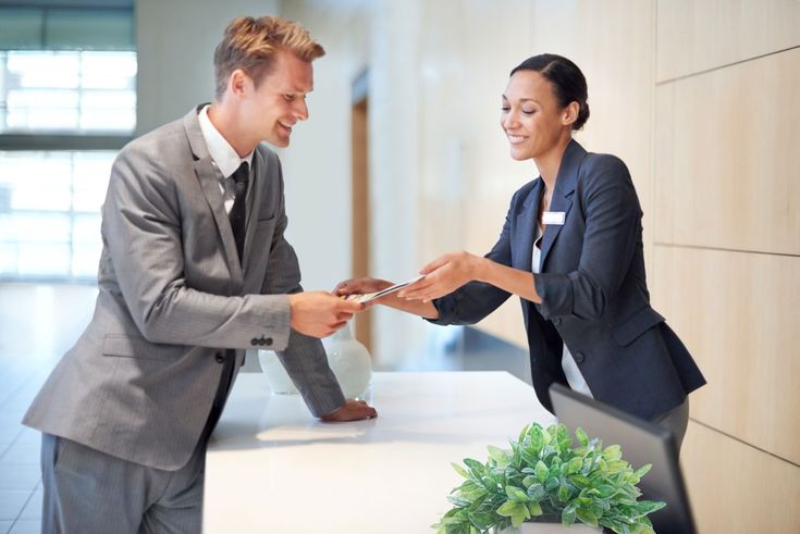 two business people shaking hands in an office