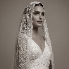 a woman wearing a wedding dress and veil