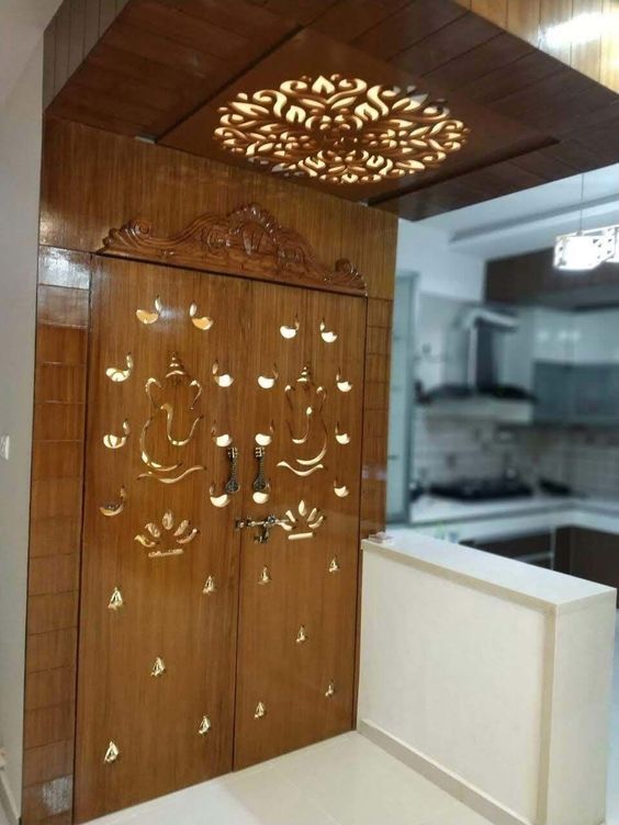 an ornate wooden door with gold decorations on the front and side panels, along with a white countertop