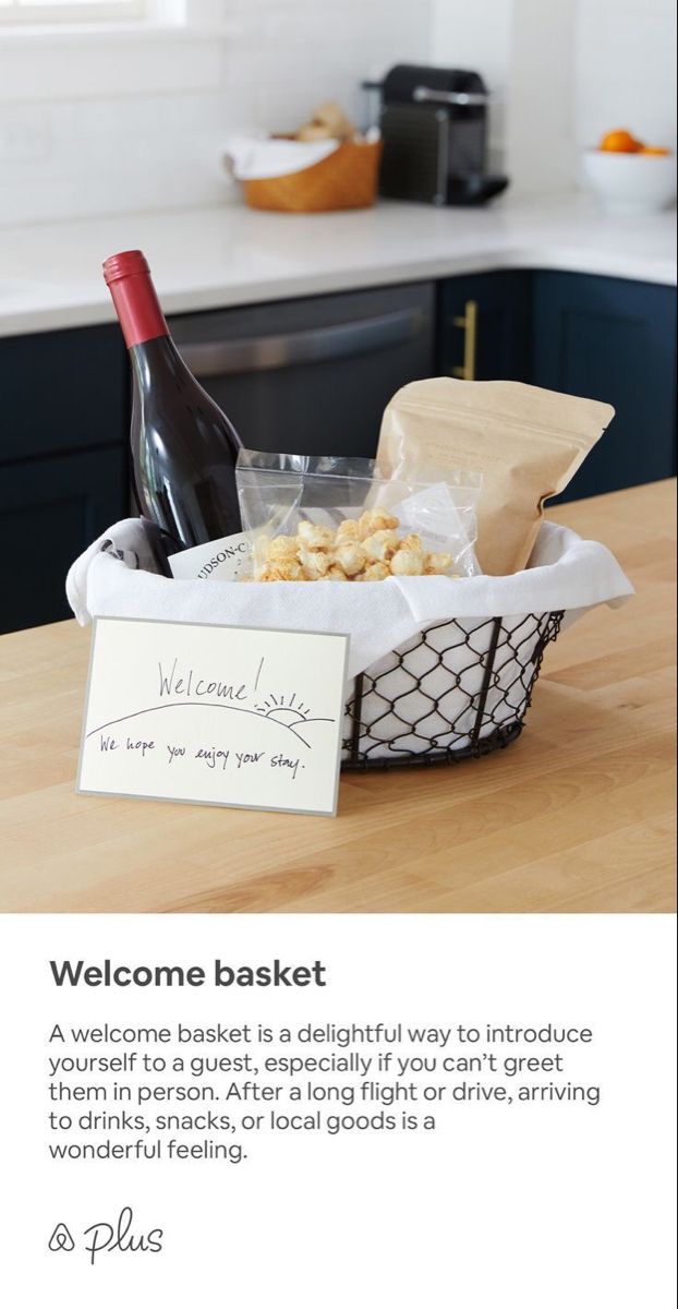 a welcome basket is shown with wine and crackers in the foreground, along with a sign that reads welcome basket