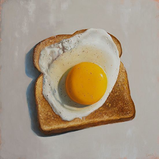 an egg is in the middle of a piece of toast