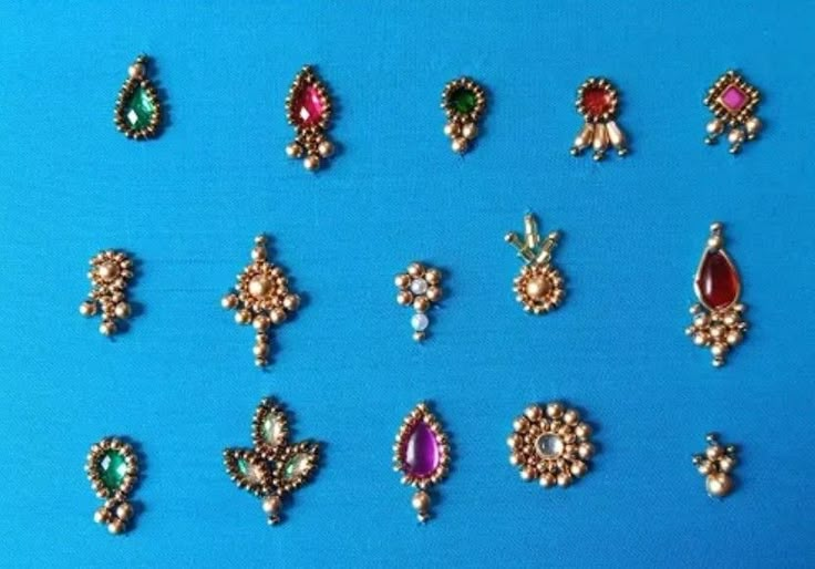 many different types of earrings on a blue background