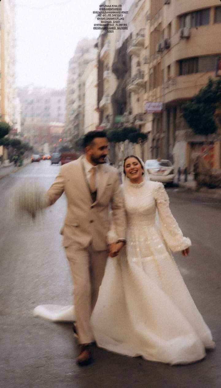 a newly married couple walking down the street