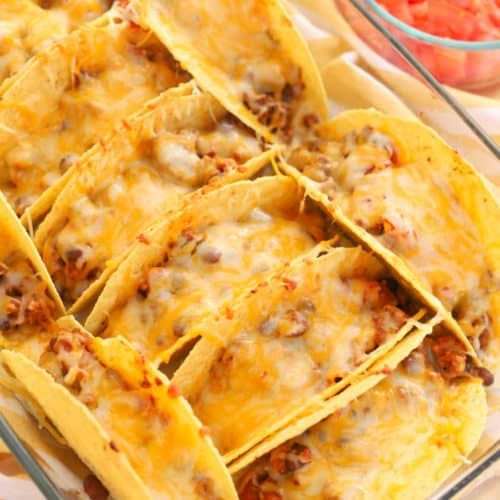 several tortilla shells with meat and cheese in a glass dish