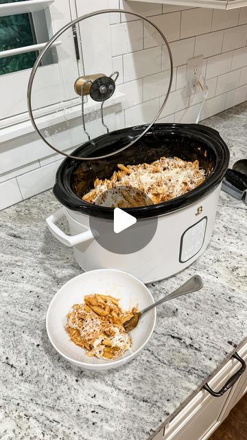 a crock pot filled with macaroni and cheese sitting on top of a kitchen counter