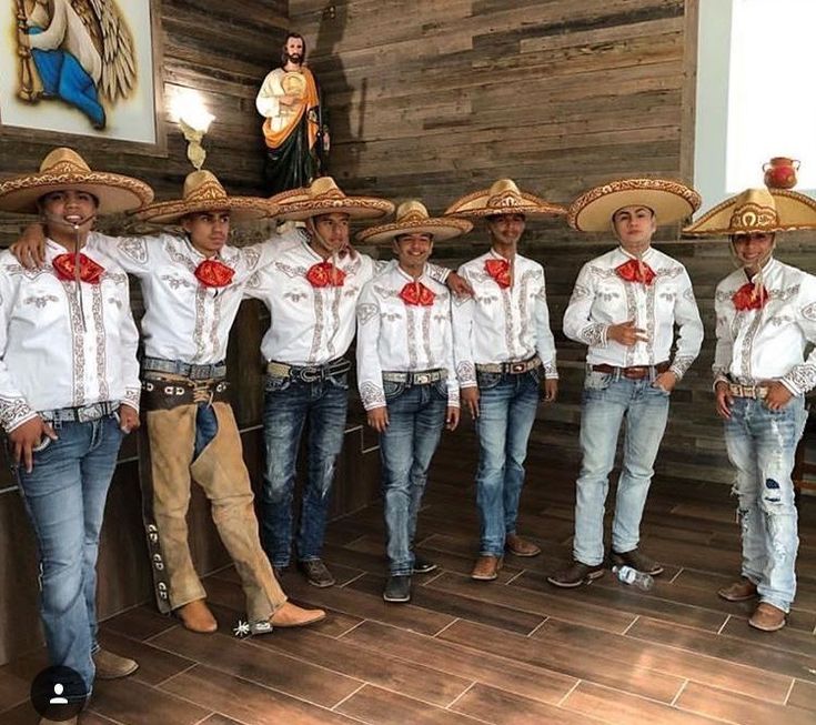 a group of men wearing sombreros standing next to each other