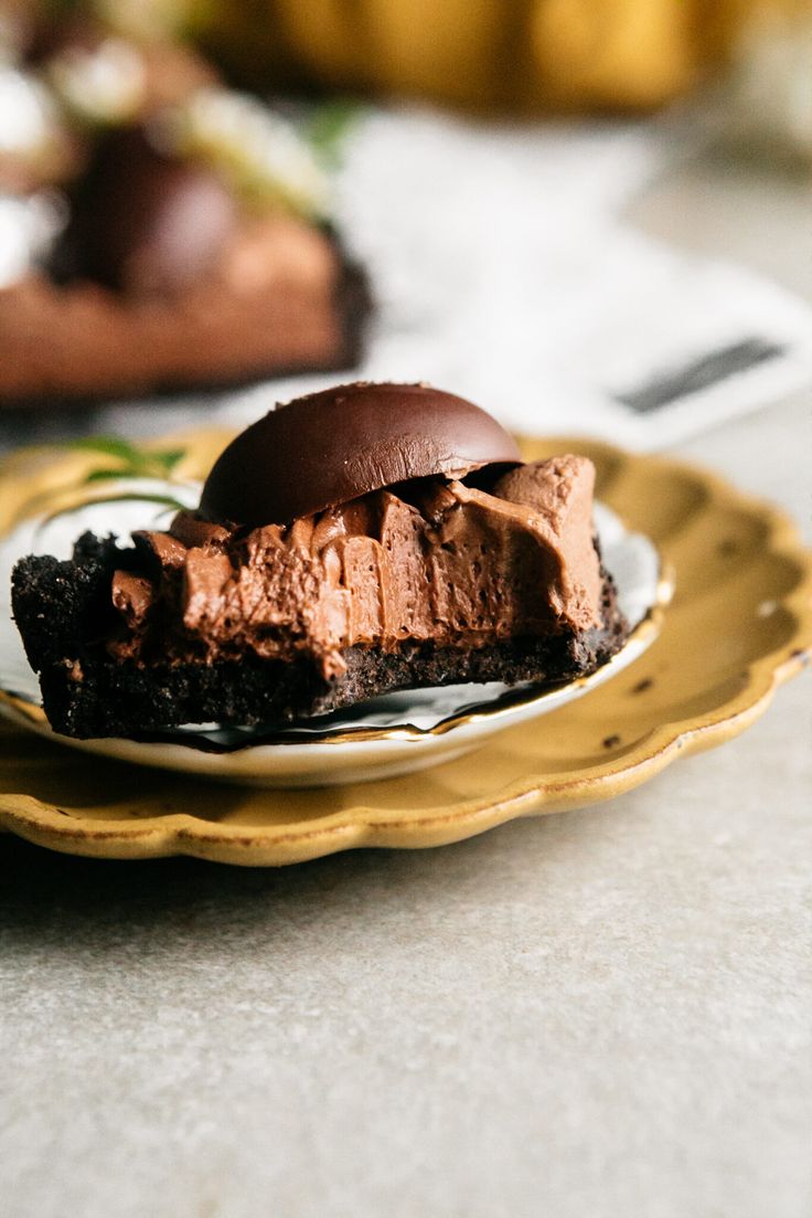 a piece of chocolate cake on a yellow and white plate