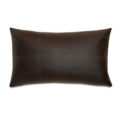 a brown leather pillow with stitching on the front and back, sitting on a white background