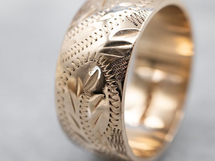 So many wonderful details come together to give this vintage band a rich, textural feel! Crafted of 14 karat yellow gold, this is a great band for stacking or wearing traditional as a wedding band!Metal: 14K Yellow GoldWidth of Band: 8.0 mmHeight off Finger: 1.4 mmRing Size: 6Marks: “<14K>” Stamped on the inside band Wide Band In 14k White Gold, Wide Band 14k White Gold, Formal Heirloom Stackable Rings With Thick Band, Antique Wide Band Engraved Jewelry, Antique Engraved Wide Band Jewelry, Stackable Wide Band 14k Gold Bands, Wide Band Stackable 14k Gold Bands, Stackable 14k Gold Wide Band, Stackable Wide Band Wedding Jewelry