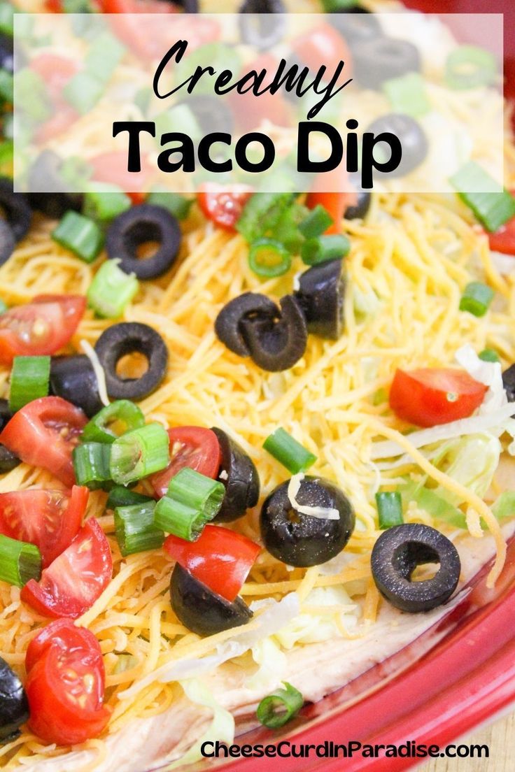 this creamy taco dip is loaded with black olives, tomatoes, green onions and cheese