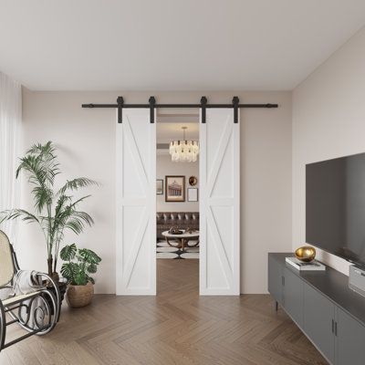 an empty living room with sliding doors leading into the dining area