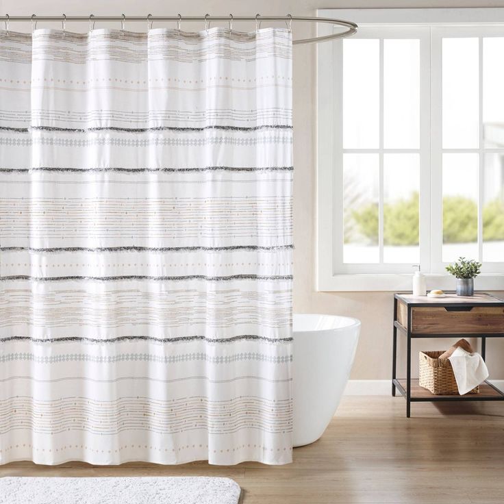 a bathroom with a tub, sink and shower curtain in it's center area