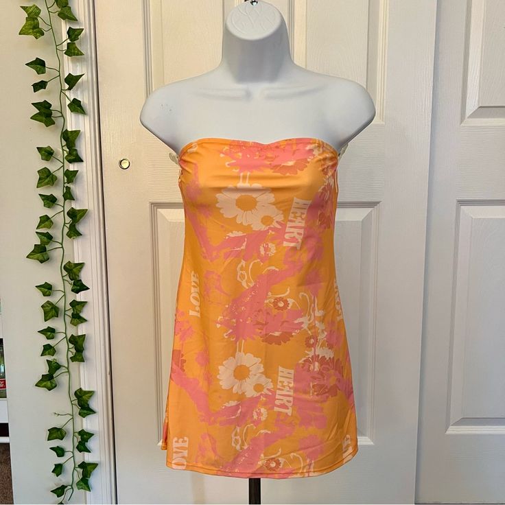 Orange And Pink Strapless Dress With A Floral Pattern #90s Princess Polly Paradise City Mini Dress Nwt Never Worn Beach Strapless Mini Dress Lined, Beach Mini Strapless Lined Dress, Strapless Mini Beach Dress, Pink Strapless Summer Sundress, Pink Strapless Dress For Spring, Pink Strapless Dress For Spring Day Out, Casual Pink Strapless Dress For Spring, Casual Strapless Pink Dress For Spring, Y2k Style Pink Mini Dress For Summer