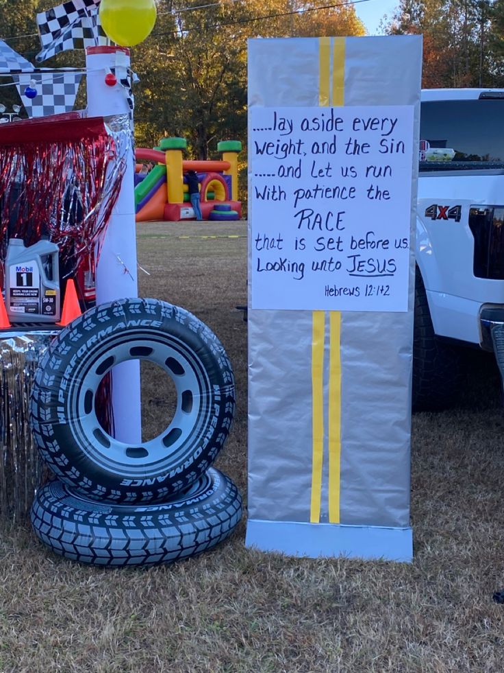 two tires are stacked on top of each other in front of a sign