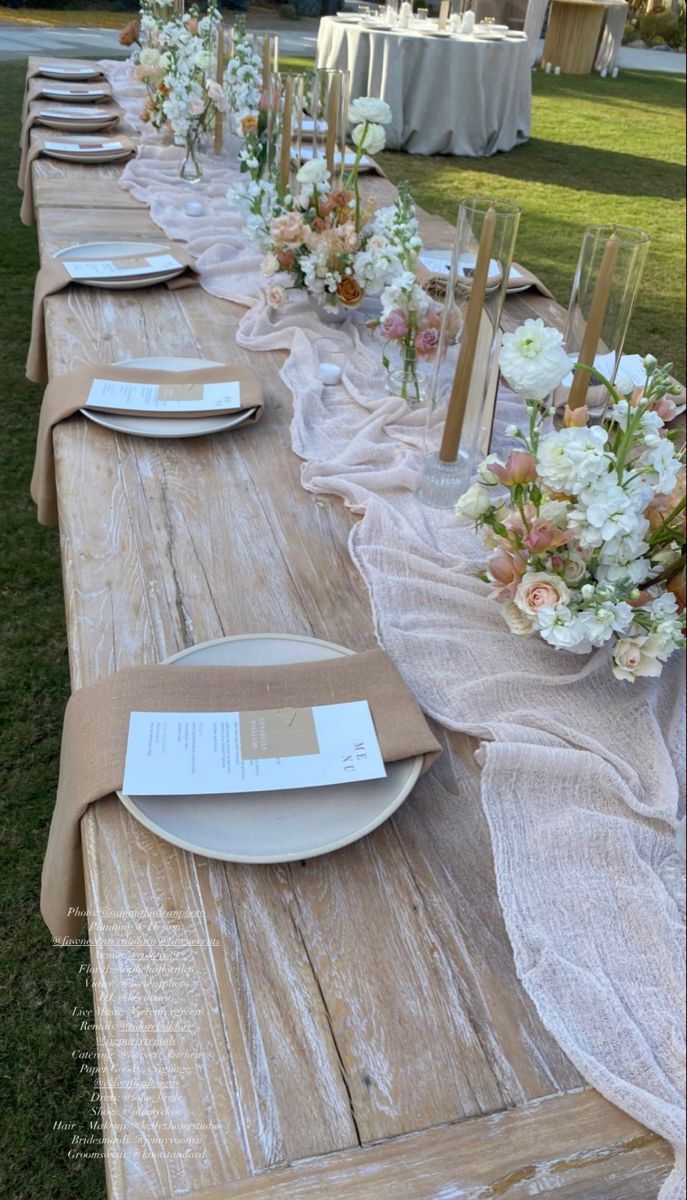 a long table with plates and place settings on it