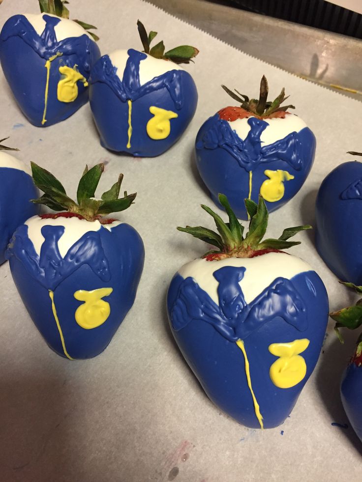 chocolate covered strawberries with yellow and white frosting