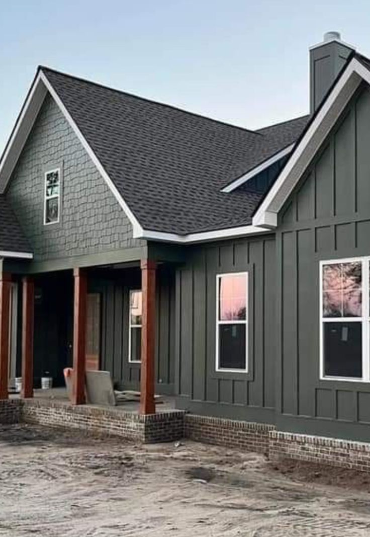 a gray house with white trim and windows