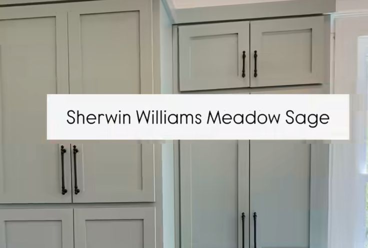 there is a sign that says sheryln williams meadow sage in front of the kitchen cabinets