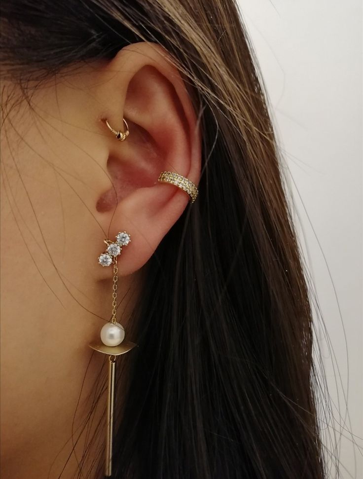 a woman's ear is shown with an ear chain attached to it