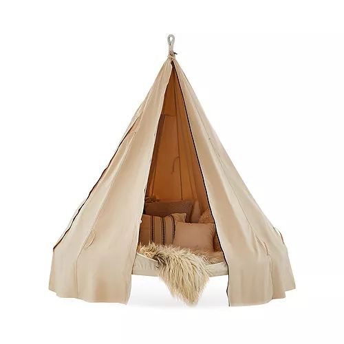 a teepee tent with pillows and blankets on it, hanging from the ceiling in front of a white background