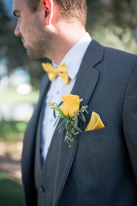 a man wearing a suit and yellow bow tie