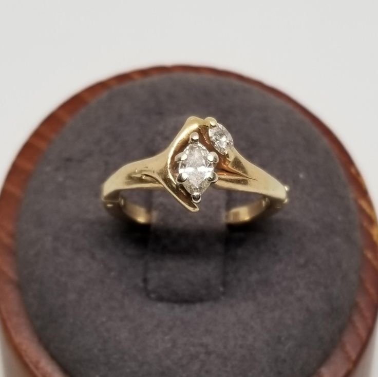 Vintage 14K Yellow Gold with an Est. .35 TCW Diamond Ring with a Convertible Setting, Size 5.5. Marked FIT 14K inside band. Main stone is approx. 5 x 3mm. Ring is 9mm wide. Weighs 2.2 dwt. We do not check prongs for wear or stones for looseness.  All items are sold as is-noting that we are a resale shop  so everything here had a previous owner! We will include flaws in the description when noted. This is one of the reasons our items are more affordable than new at a jewelry store. Are these stones real or fake? Aside from diamonds, we do not know if any gemstones are natural or synthetic. We will state on certain gemstones, that we know 100%, if they are created or fake due to their lack of inclusions. For this reason, we do not sell any diamonds without inclusions, and the larger diamonds Unconventional Engagement Rings Vintage, Classic Formal Bypass Ring, Formal Marquise Tension Setting Wedding Jewelry, Formal 14k Gold Bypass Ring With Single Diamond, Marquise Tension Setting Formal Jewelry, Fine Jewelry Bypass Ring With Single Diamond For Anniversary, Elegant 14k Stamped Bypass Ring For Anniversary, Formal 14k Gold Bypass Ring With Tension Setting, Vintage 14k Gold Diamond Ring With Center Stone