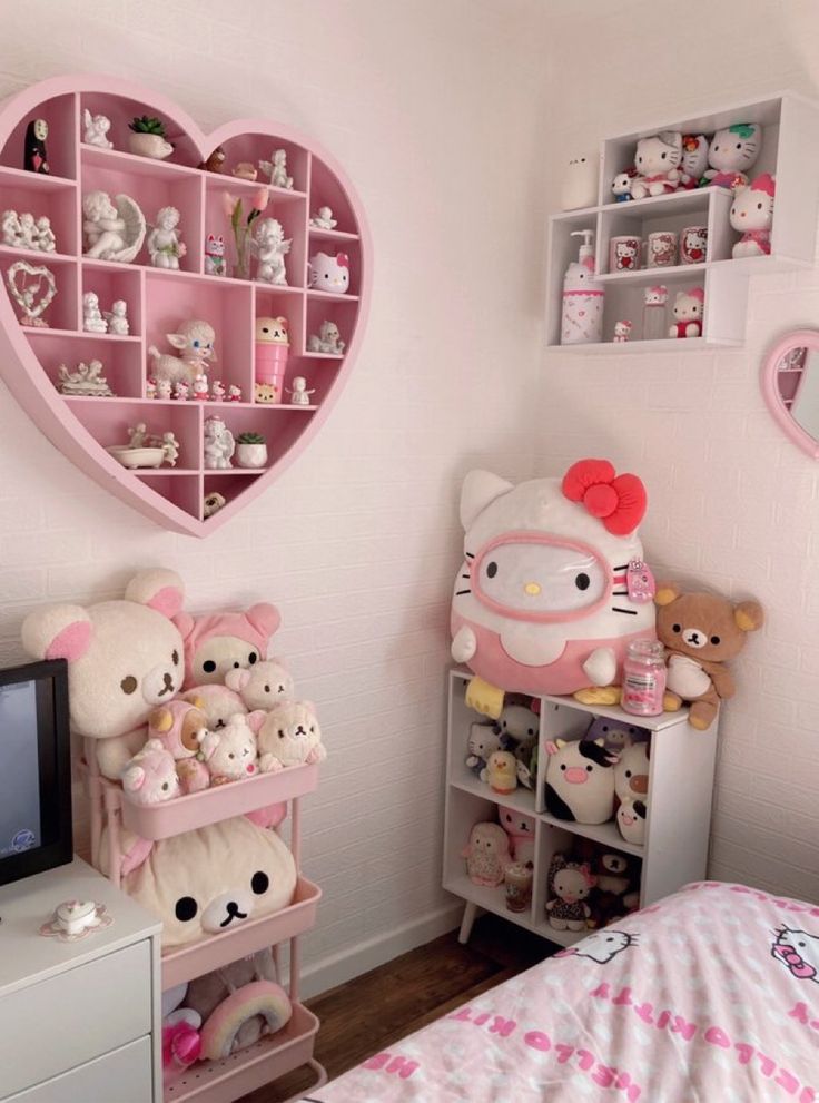 a bedroom with hello kitty decorations on the wall and shelves in the shape of a heart