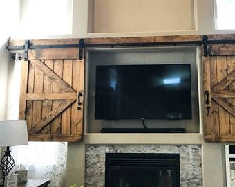 a living room with a large flat screen tv mounted on the wall above a fireplace